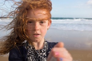 windswept-young-girl-at-the-beach-austockphoto-000002400